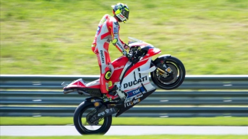 Italian rider Andrea Iannone of Ducati team wheelies during the qualifying session at the Grand Prix in Spielberg  Austria  on August 13  2016    AFP PHOTO   JOE KLAMAR